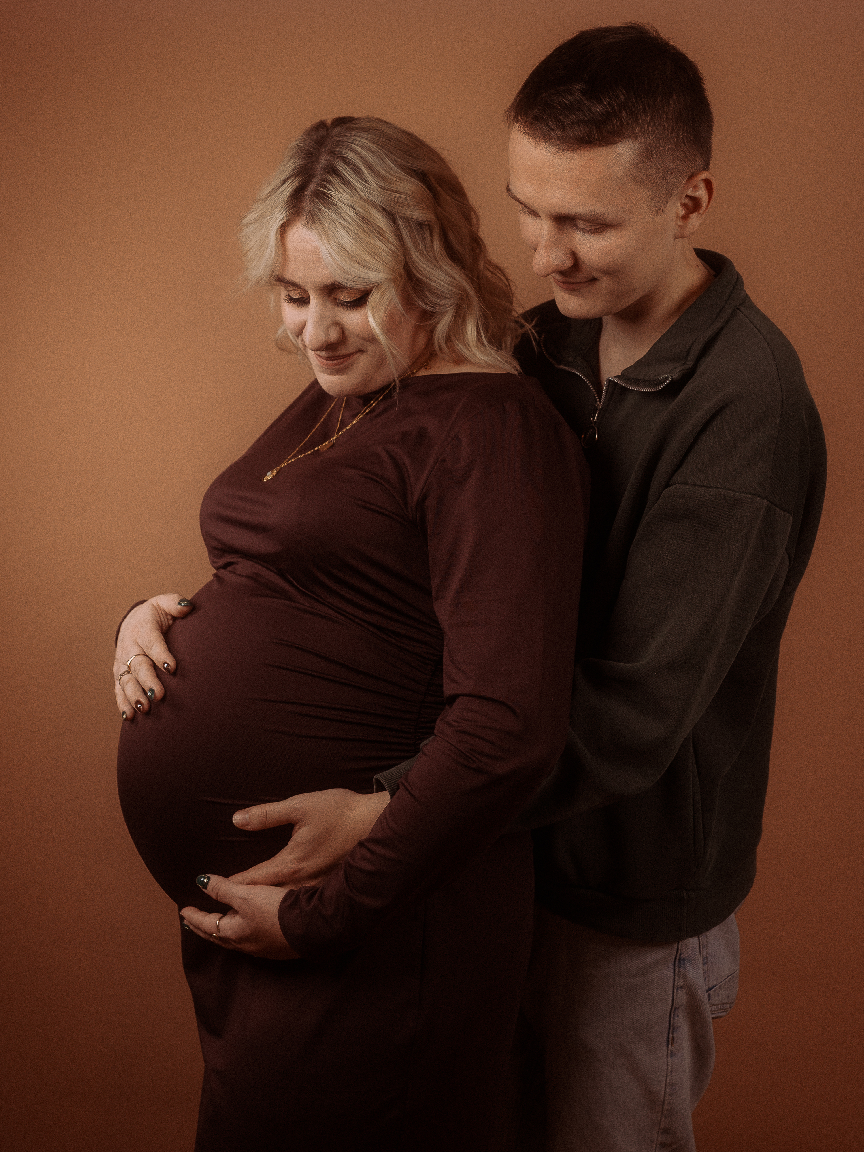 Schwangere Frau mit Partner, braunes Kleid. Hochzeit am Haus Heinz am See.