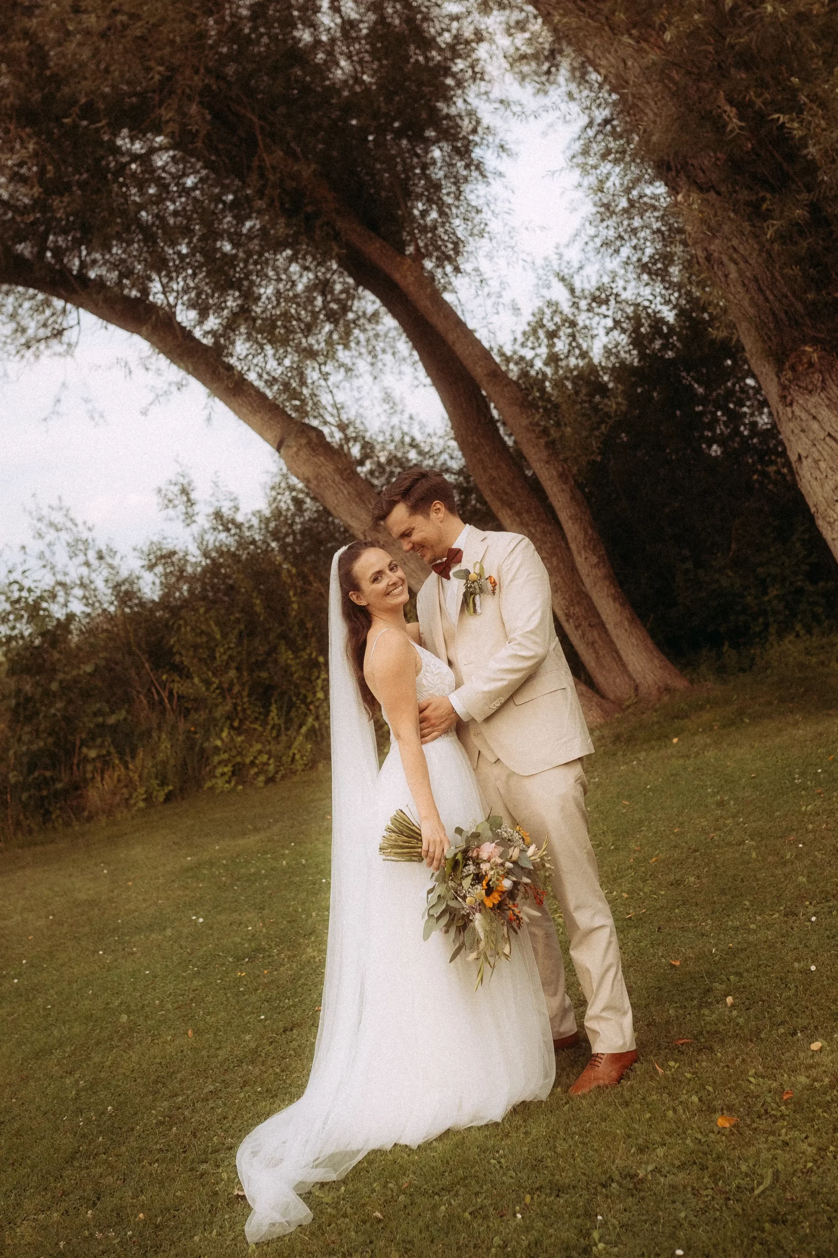 Bride and groom embrace, wedding photographer