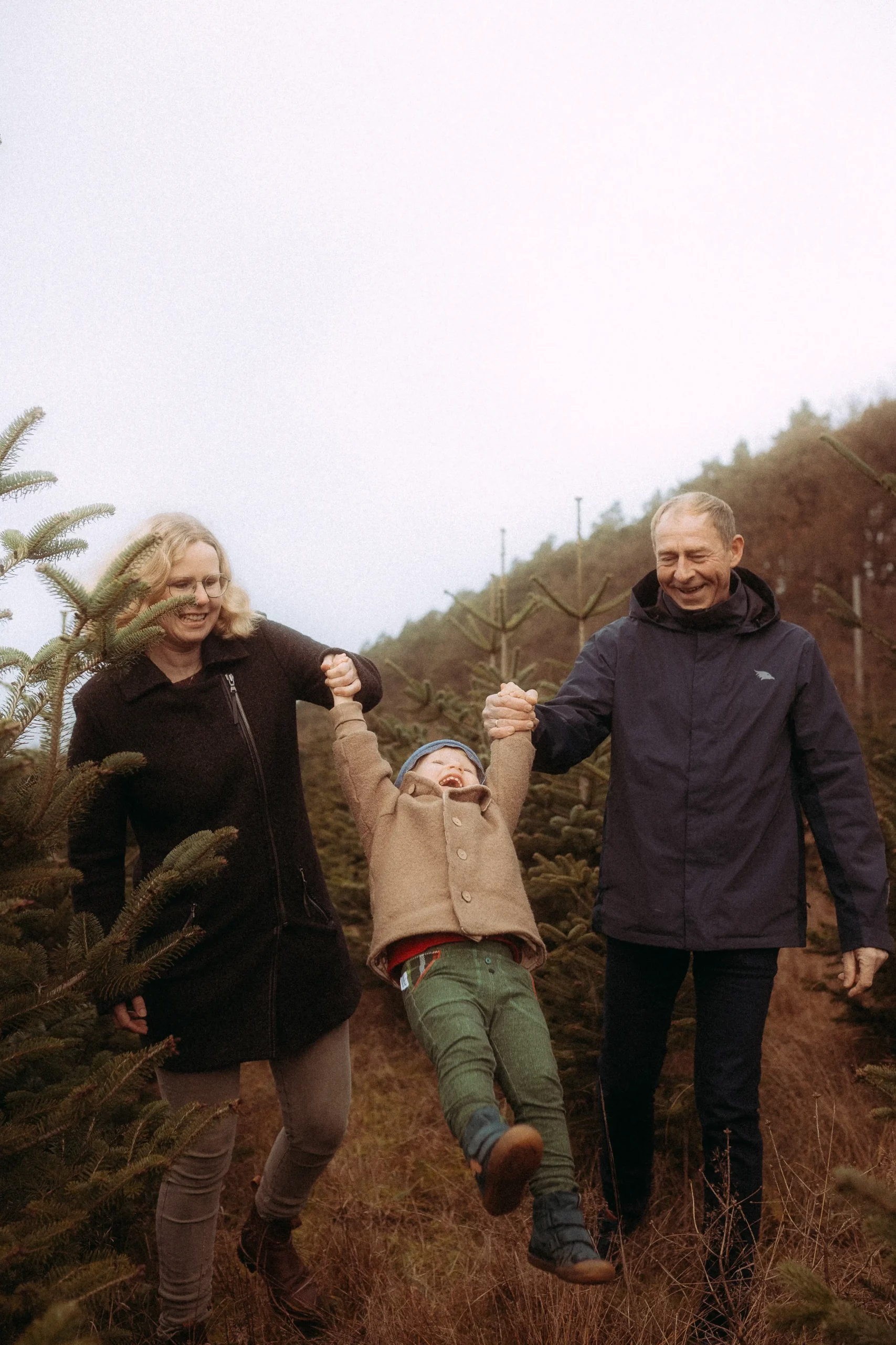 Familie hat Spaß auf dem Weihnachtsbaumhof